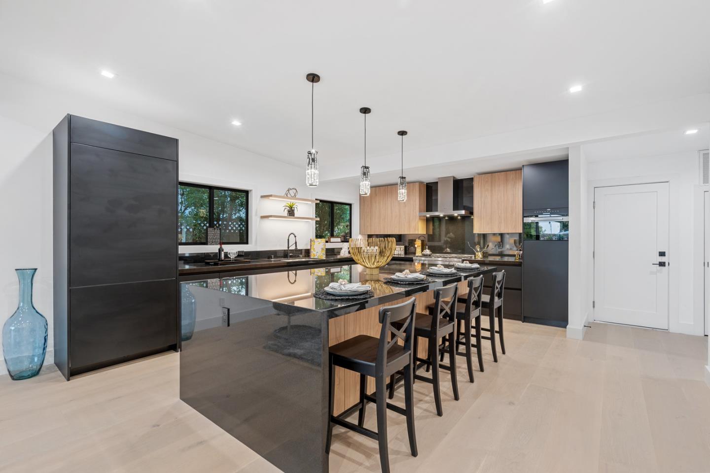3633 Louis Road Palo Alto, CA 94303 - Photo 4 of 42 a kitchen with stainless steel appliances kitchen island granite countertop a dining table chairs and a refrigerator