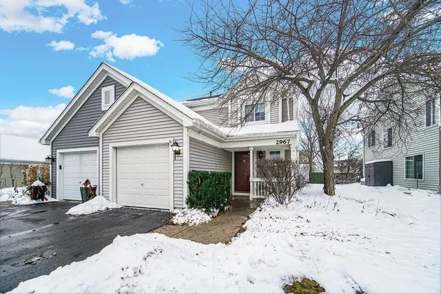 a view of a house with snow on the road