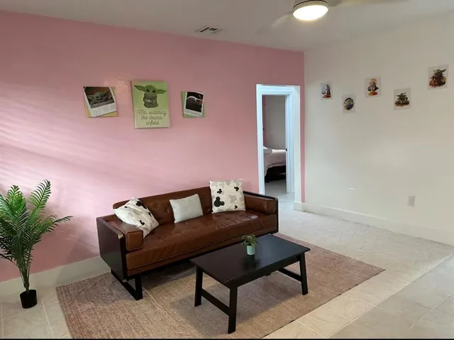 a living room with furniture and flowers