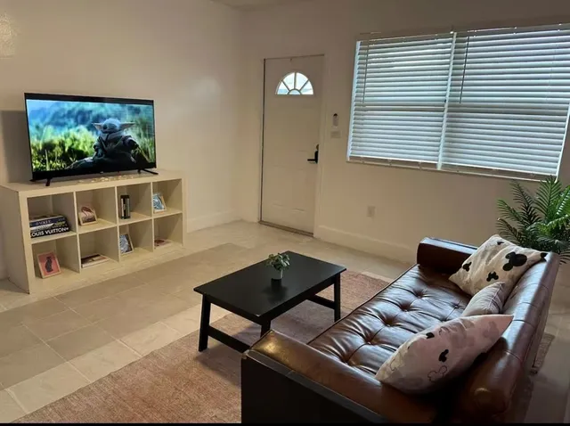 a living room with furniture and a flat screen tv