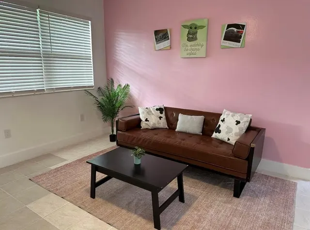 a living room with furniture and a window