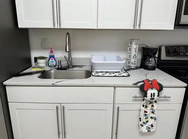a kitchen with a stove and cabinets