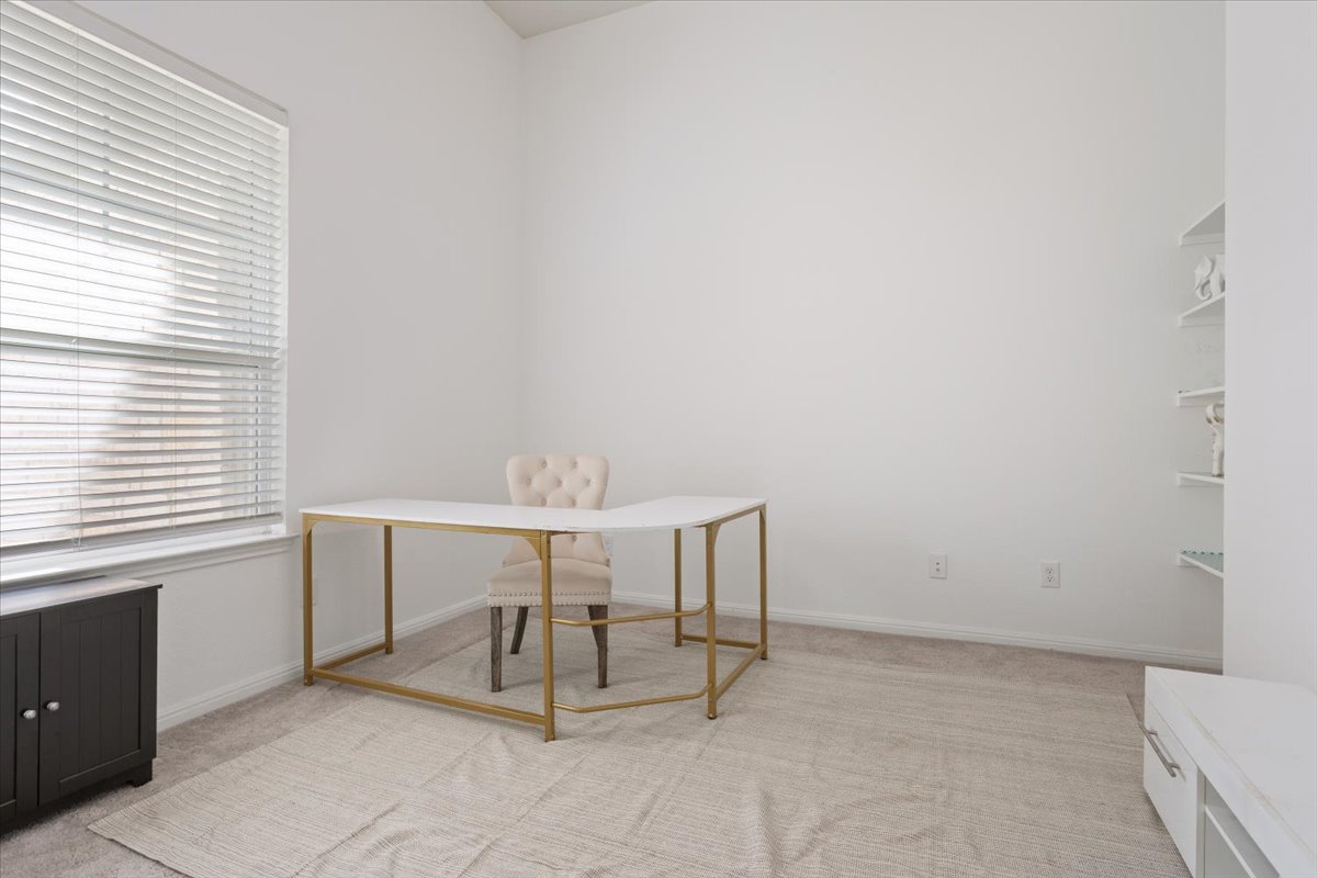 3625 Garrano Bend Leander, TX 78641 - Photo 26 of 38 Well-lit office area, perfect for productivity, features plush carpeting and convenient built-in shelving. This room could easily be a 5th bedroom.