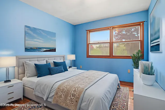 a bedroom with a large bed and a window