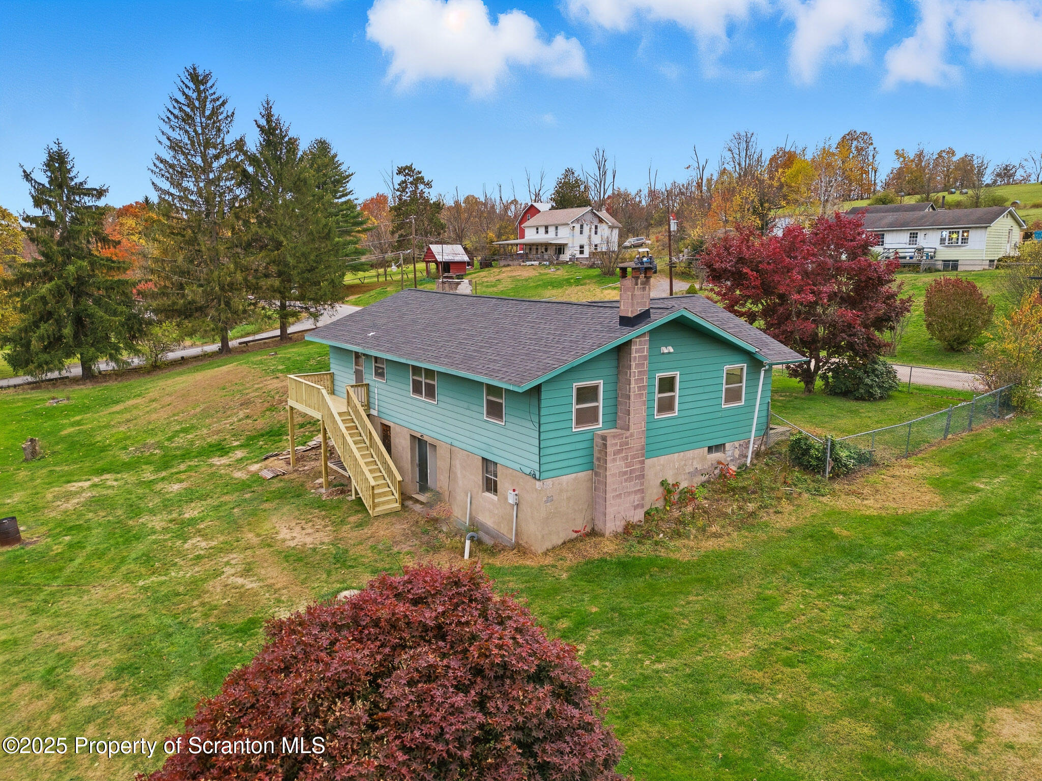 330 Pedrick Road Nicholson, PA 18446 - Photo 5 of 55 a view of a house with a big yard and large trees