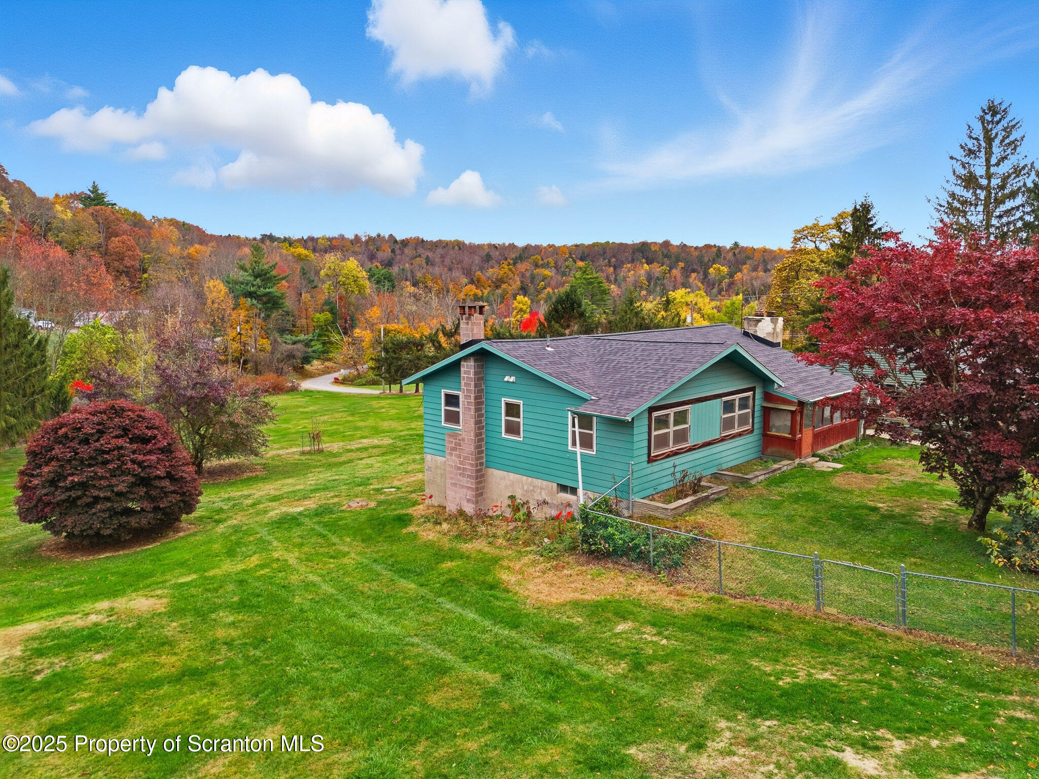 330 Pedrick Road Nicholson, PA 18446 - Photo 6 of 55 a view of a house with a big yard and large trees