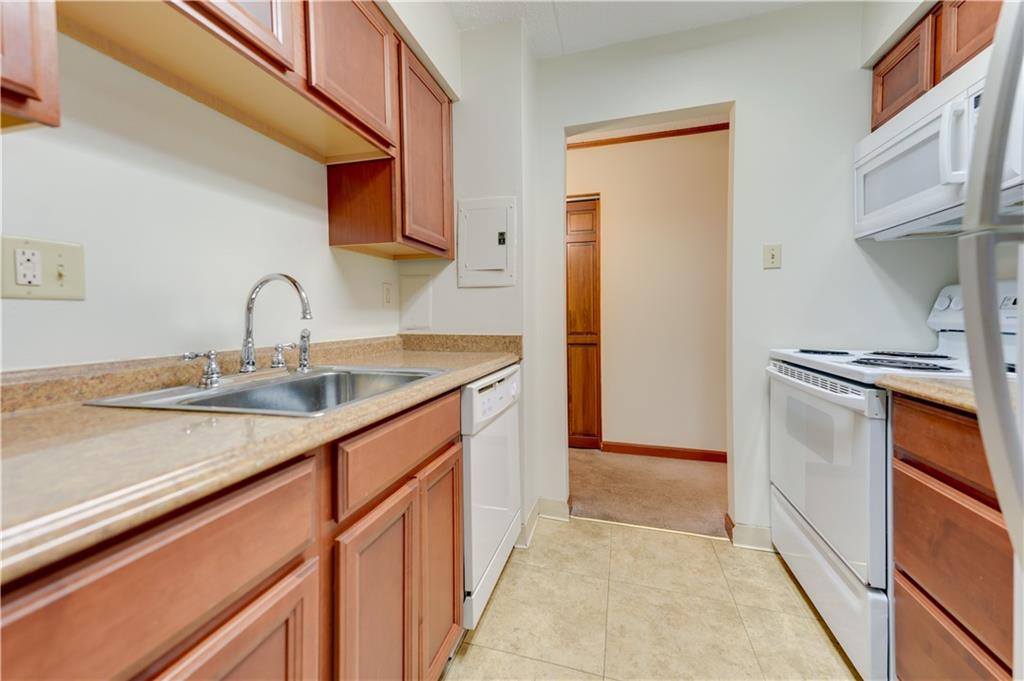 2160 Greentree Road, Unit 401W Pittsburgh, PA 15220 - Photo 7 of 23 a kitchen with a sink and a refrigerator