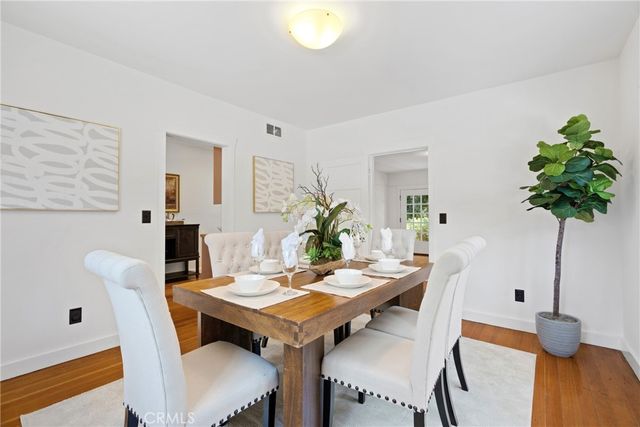 a view of a room with wooden floor and windows
