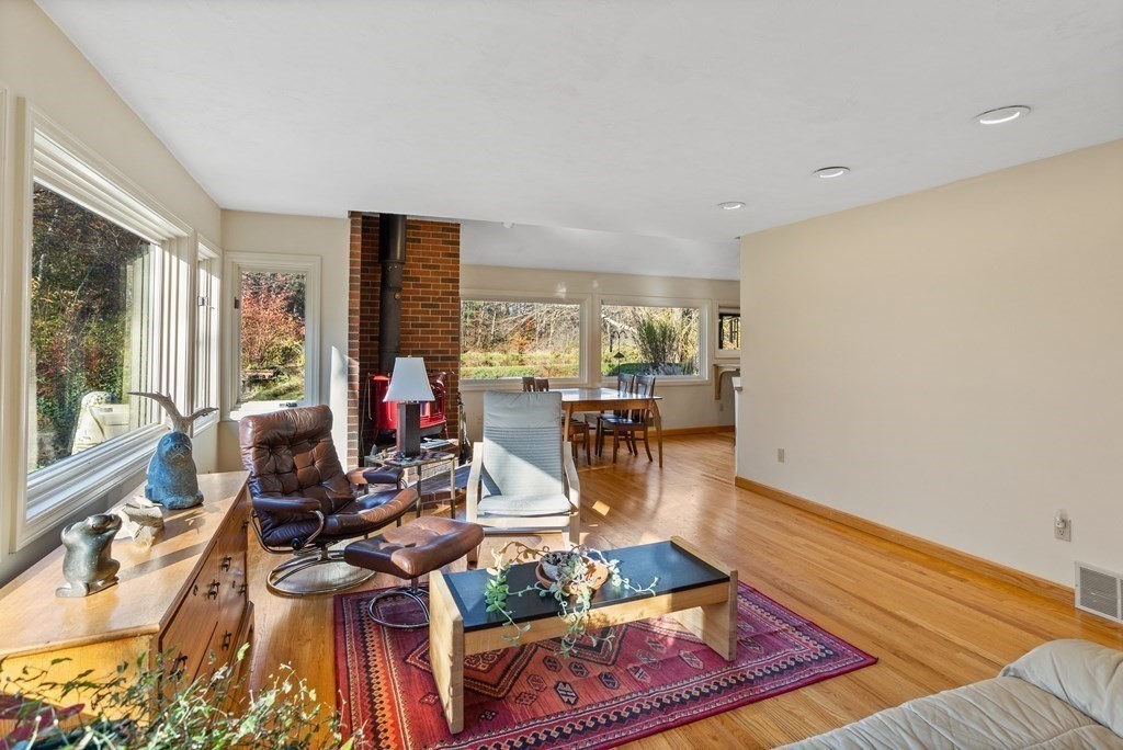 115 South Meadow Road Lancaster, MA 01523 - Photo 11 of 42 a living room with furniture and a table