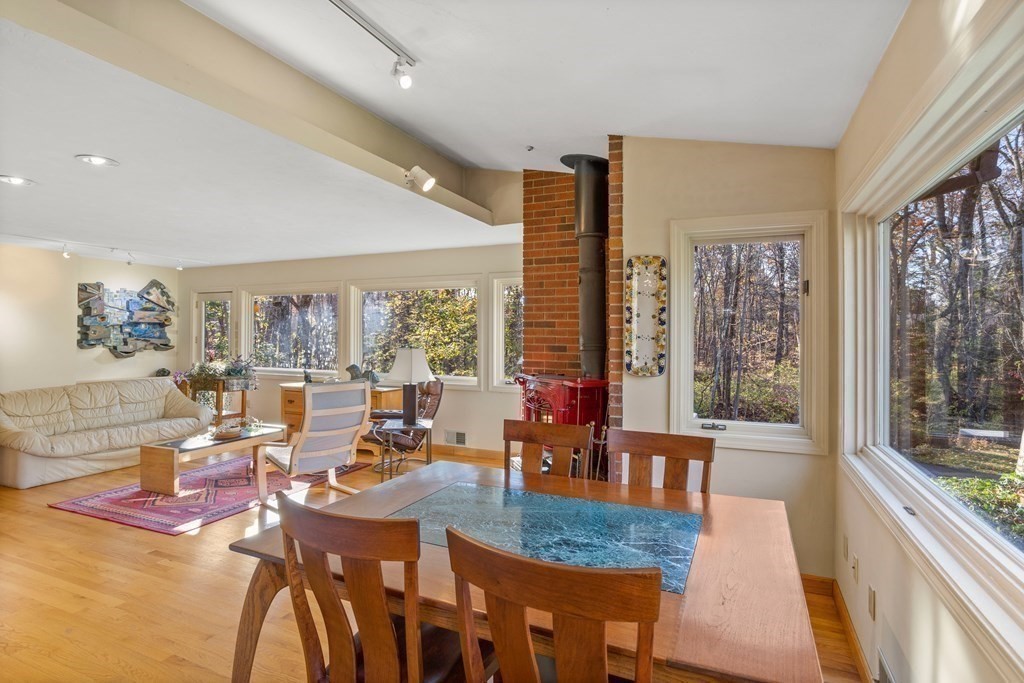 115 South Meadow Road Lancaster, MA 01523 - Photo 14 of 42 a dining room with furniture a chandelier and wooden floor