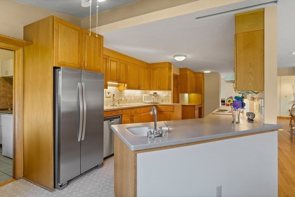 115 South Meadow Road Lancaster, MA 01523 - Photo 16 of 42 a kitchen with stainless steel appliances a sink and refrigerator