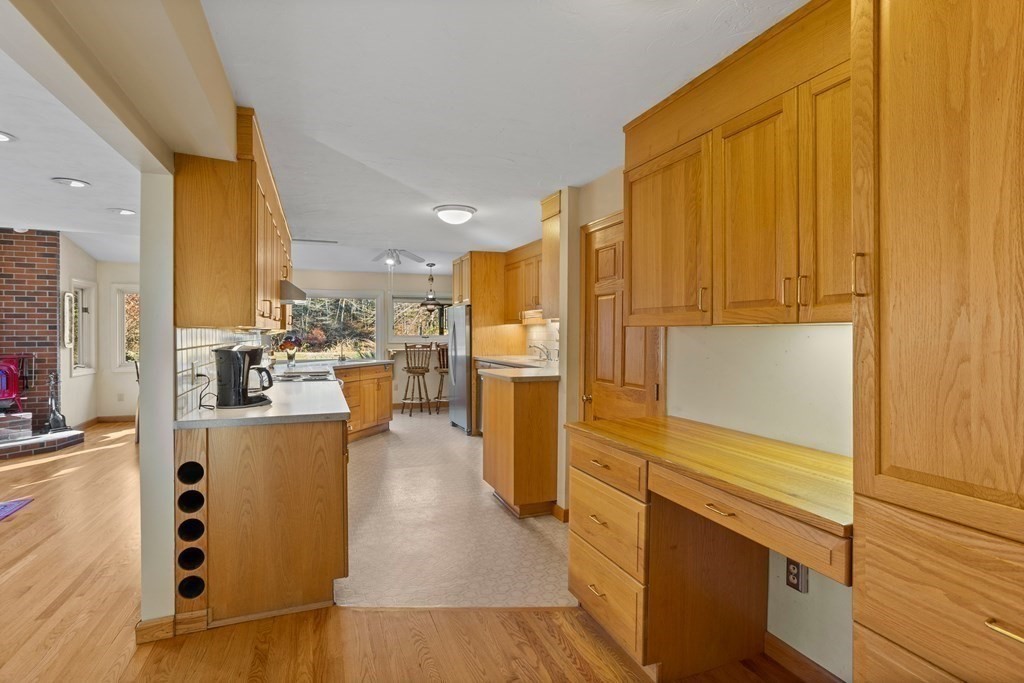 115 South Meadow Road Lancaster, MA 01523 - Photo 18 of 42 a view of a kitchen with stainless steel appliances wooden floor and a large window