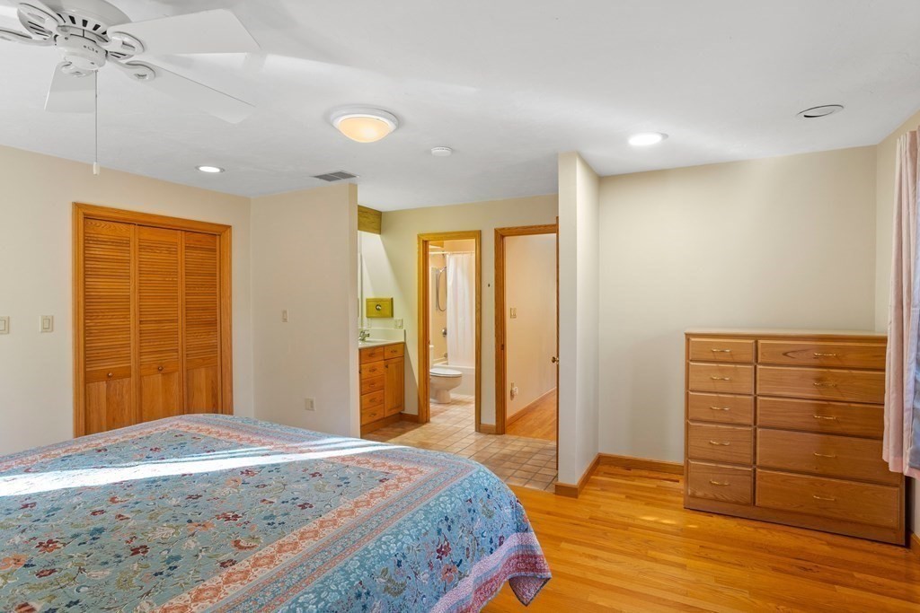115 South Meadow Road Lancaster, MA 01523 - Photo 23 of 42 a bedroom with a bed and wooden floor