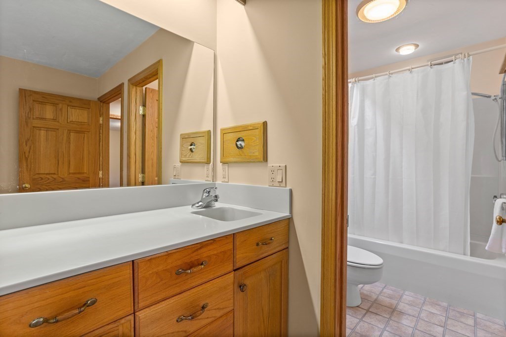 115 South Meadow Road Lancaster, MA 01523 - Photo 24 of 42 a bathroom with a granite countertop sink and a mirror