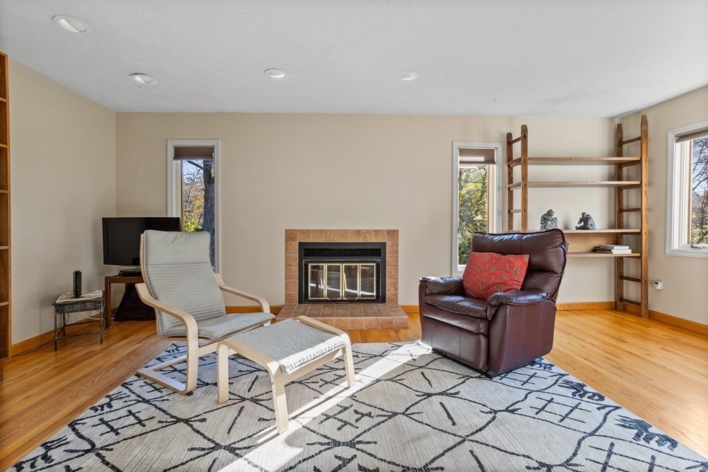 115 South Meadow Road Lancaster, MA 01523 - Photo 5 of 42 a living room with furniture a rug and a fireplace