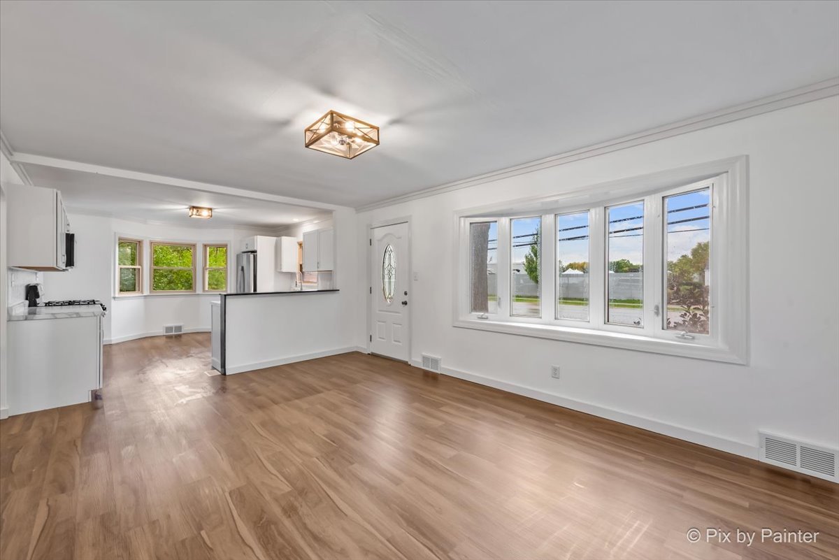 3019 Lincoln Road McHenry, IL 60051 - Photo 6 of 28 a view of an empty room with a window and wooden floor