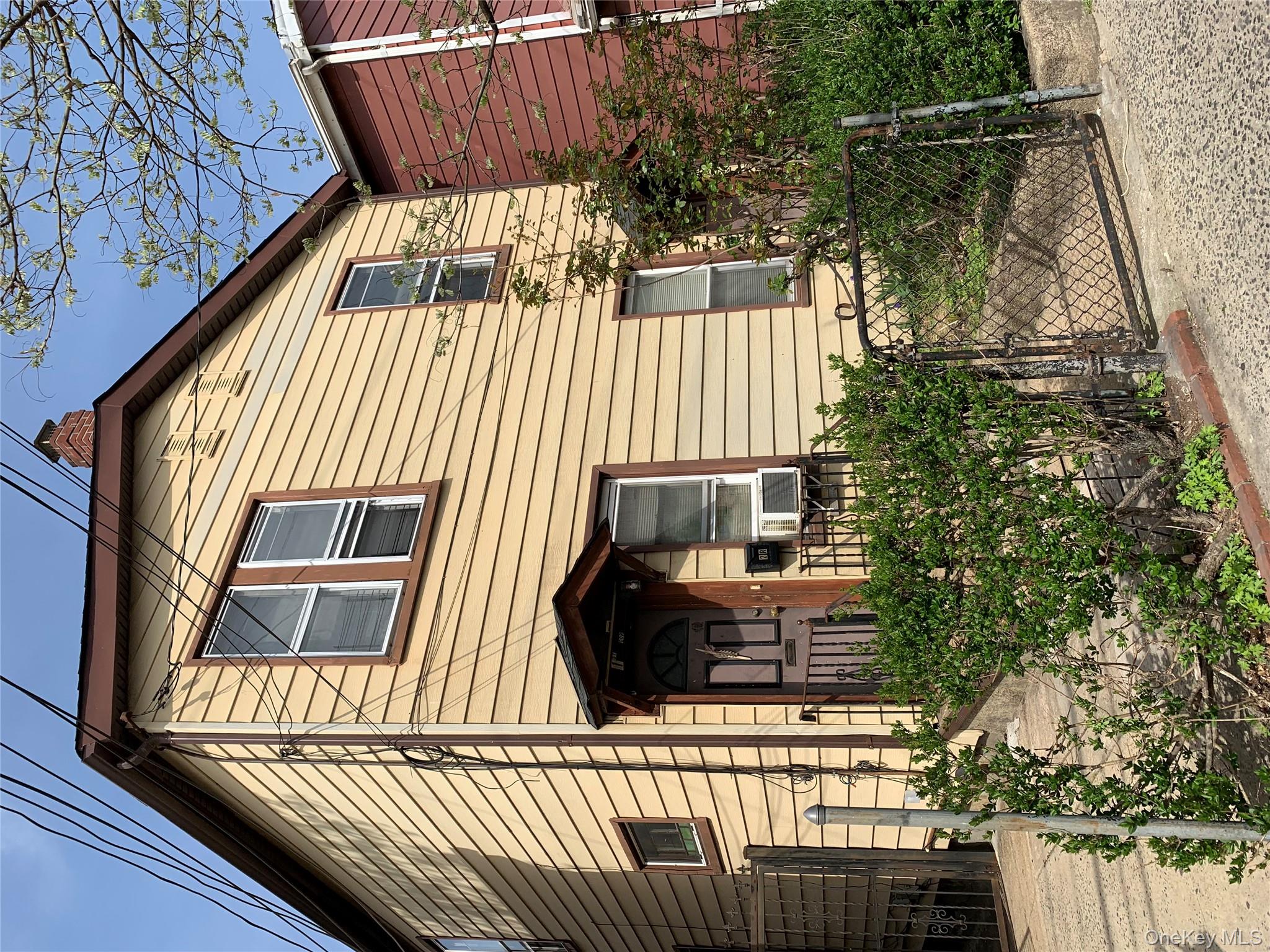 View of front of house featuring a gate and a chimney