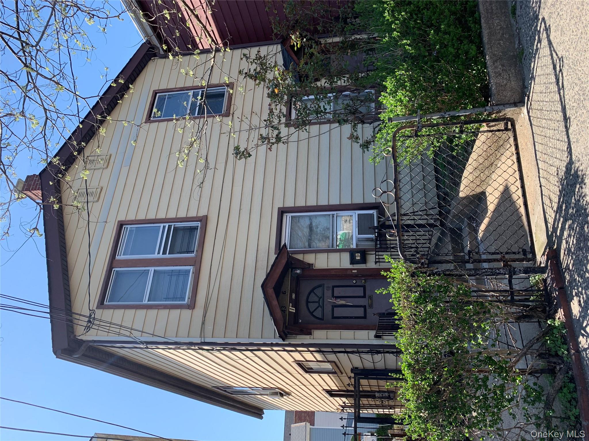43-16 Junction Boulevard Queens, NY 11368 - Photo 2 of 2 a front view of a house with garden