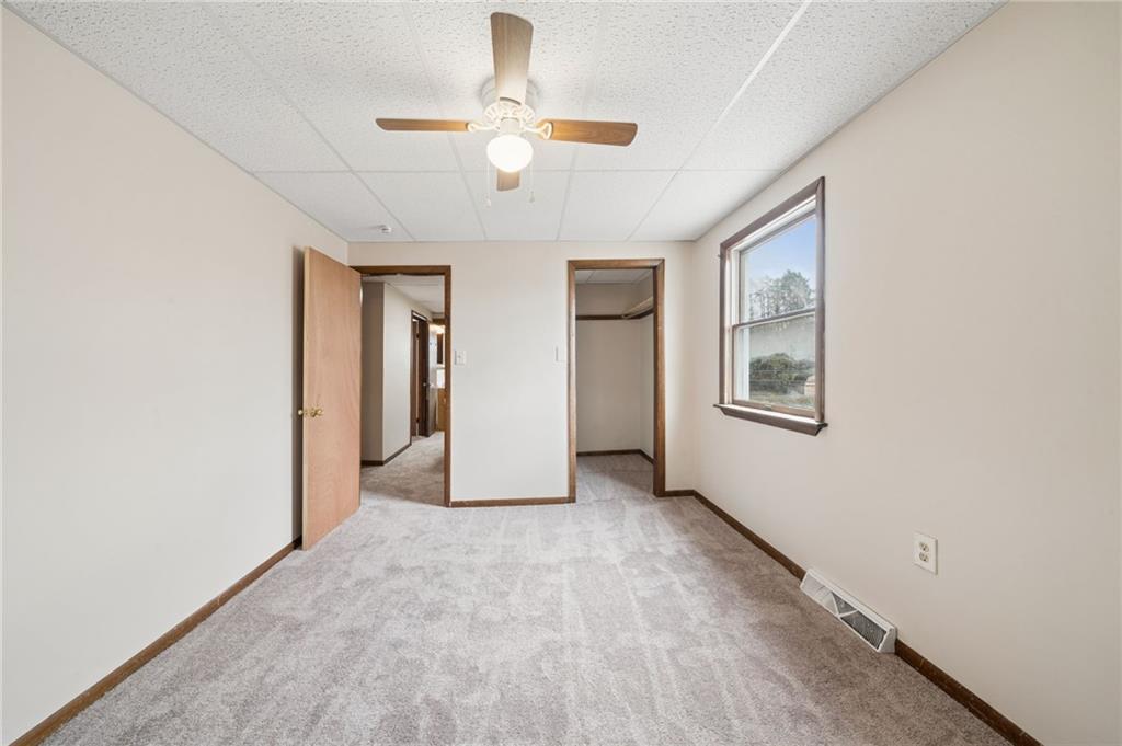 504 Fair Oaks Street McKees Rocks, PA 15136 - Photo 23 of 35 an empty room with windows and ceiling fan