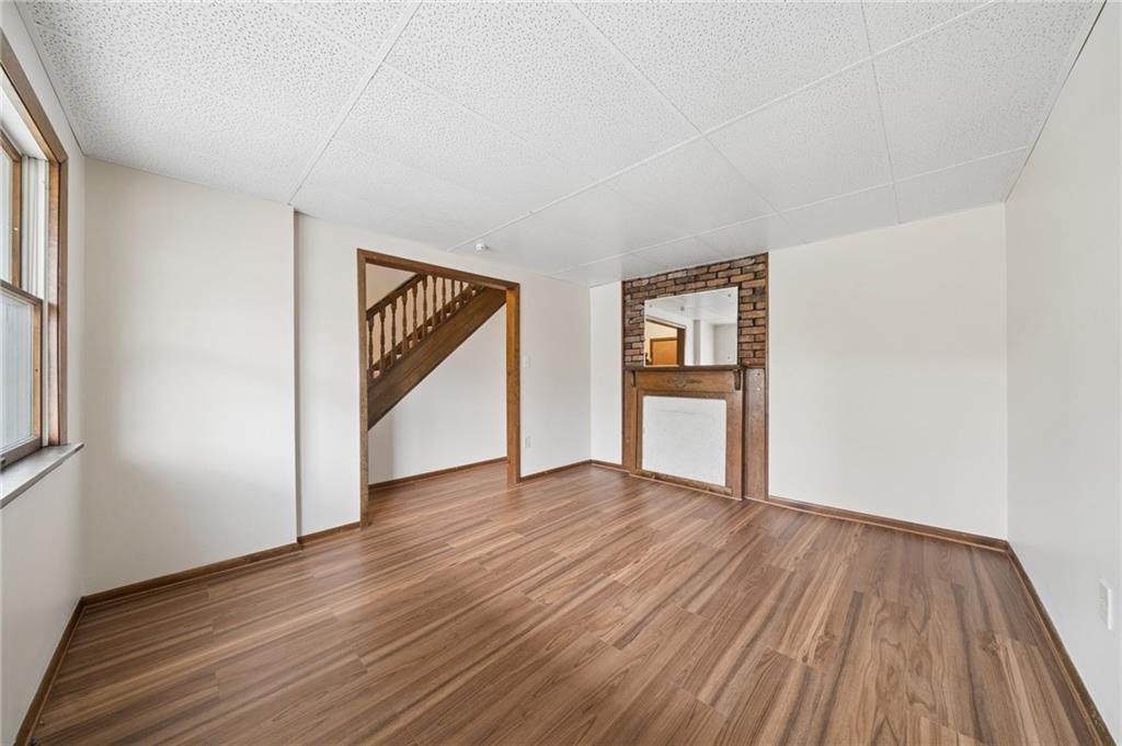 504 Fair Oaks Street McKees Rocks, PA 15136 - Photo 5 of 35 a view of an empty room with wooden floor and a window