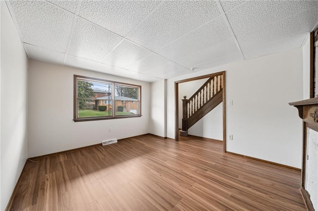 504 Fair Oaks Street McKees Rocks, PA 15136 - Photo 7 of 35 a view of an empty room with wooden floor and a window
