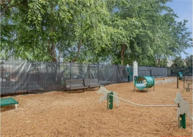 a backyard of a house with lawn chairs and a fire pit
