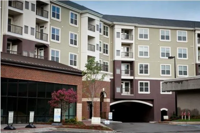 a front view of a building with a garden