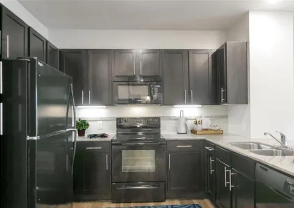 a kitchen with a sink and stainless steel appliances