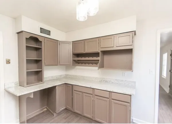 a kitchen with cabinets and window