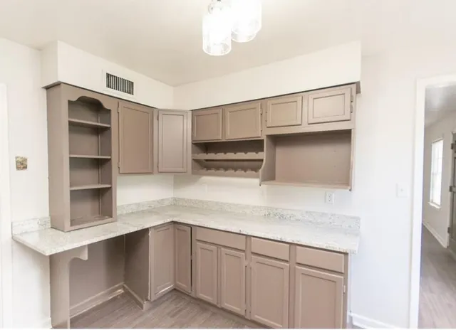 a kitchen with cabinets and window