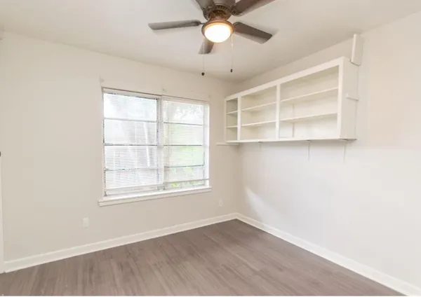 an empty room with a empty space and windows