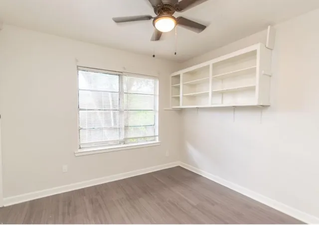 an empty room with a empty space and windows