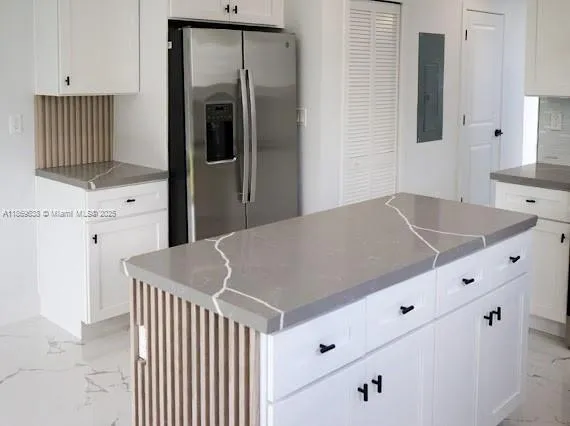 a kitchen with cabinets and stainless steel appliances