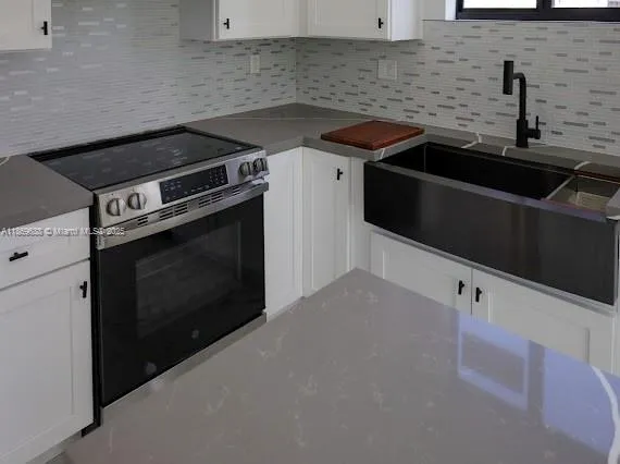 a kitchen with a stove and a microwave