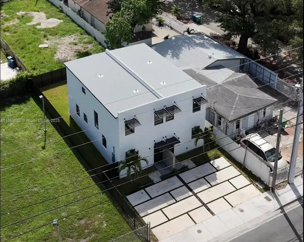 an aerial view of a house with a yard