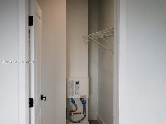 a view of storage and utility room with racks on the wall