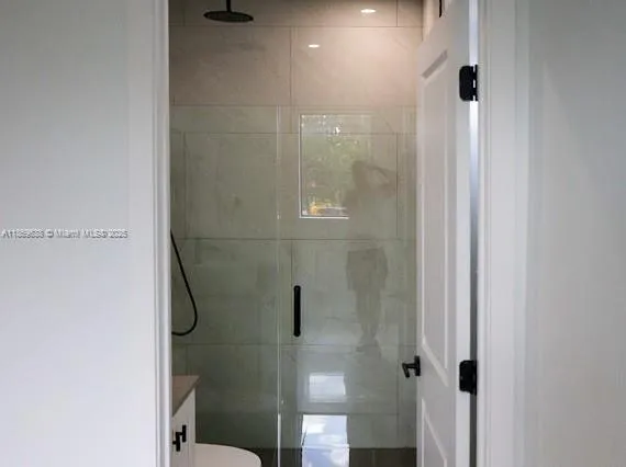 a view of a hallway with wooden floor and mirror