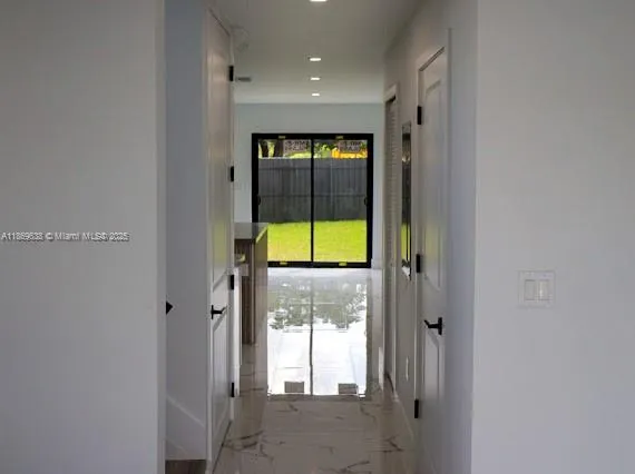 a view of a hallway with a window