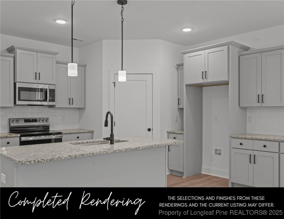 3563 Philippi Church Road Raeford, NC 28376 - Photo 3 of 11 a kitchen with kitchen island granite countertop a sink a counter space stainless steel appliances and cabinets