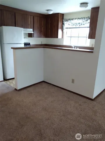 a kitchen with stainless steel appliances a refrigerator sink and cabinets