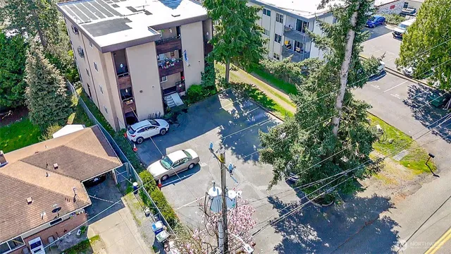 an aerial view of a house with a yard and large trees