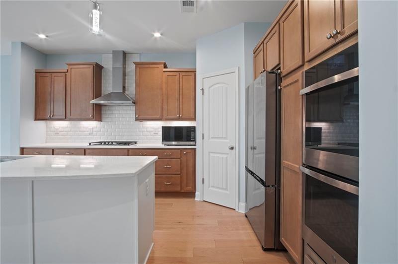 7945 Garnet Trace Ball Ground, GA 30107 - Photo 14 of 73 a kitchen with kitchen island granite countertop appliances cabinets and a sink