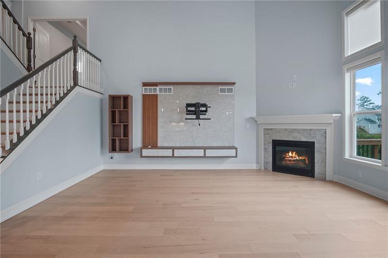 7945 Garnet Trace Ball Ground, GA 30107 - Photo 20 of 73 a view of a livingroom with fireplace and window
