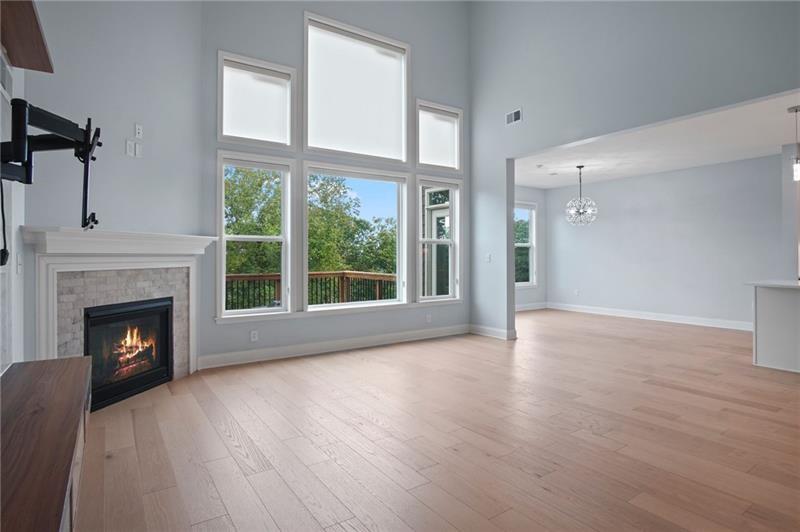 7945 Garnet Trace Ball Ground, GA 30107 - Photo 21 of 73 a view of an empty room with wooden floor fireplace and a window