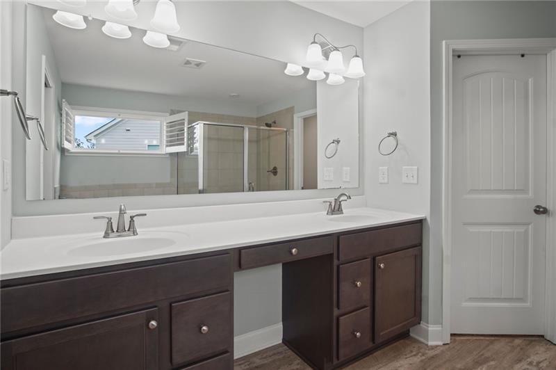 7945 Garnet Trace Ball Ground, GA 30107 - Photo 32 of 73 a bathroom with a sink double vanity and a mirror