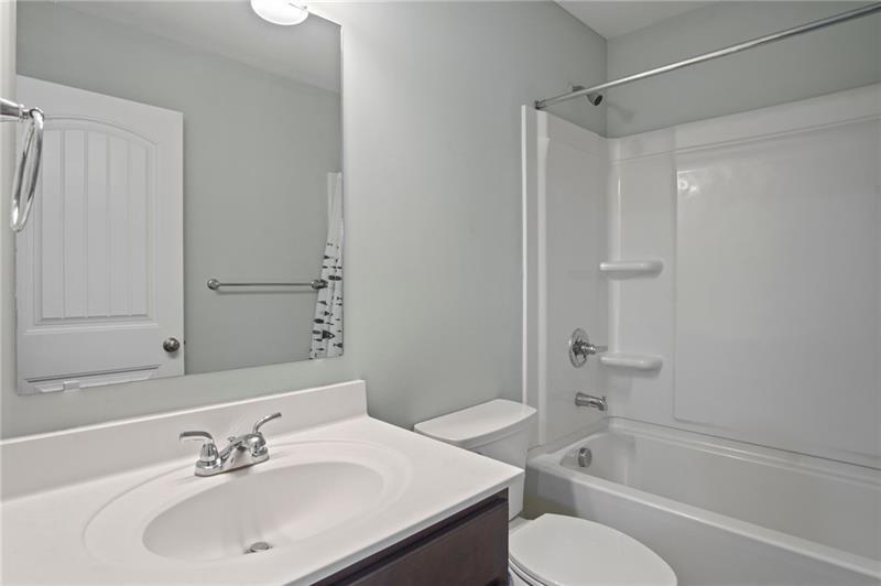 7945 Garnet Trace Ball Ground, GA 30107 - Photo 38 of 73 a bathroom with a sink toilet and shower