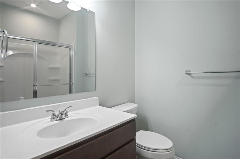 7945 Garnet Trace Ball Ground, GA 30107 - Photo 42 of 73 a bathroom with a sink toilet and vanity