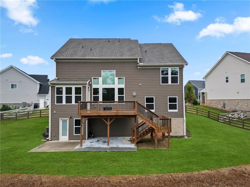 7945 Garnet Trace Ball Ground, GA 30107 - Photo 58 of 73 a front view of house with yard and outdoor seating