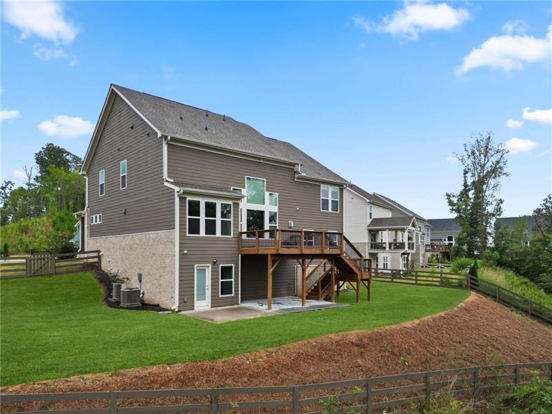 7945 Garnet Trace Ball Ground, GA 30107 - Photo 61 of 73 a front view of a house with a garden
