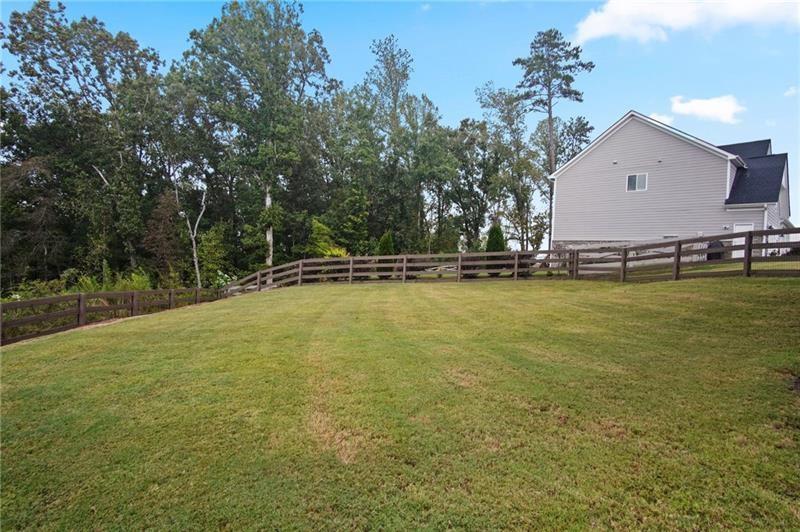 7945 Garnet Trace Ball Ground, GA 30107 - Photo 66 of 73 a view of a swimming pool with an outdoor space and seating area